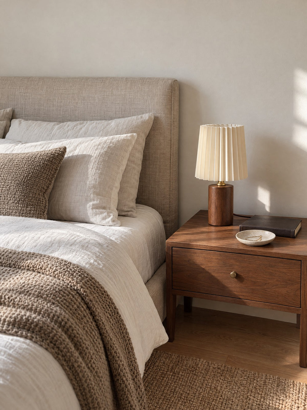 Linnea Pleated Wood Nightstand Lamp on a nightstand in daylight