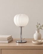 Luna Ribbed Opal Glass Nightstand Lamp on a nightstand top against a plain backdrop