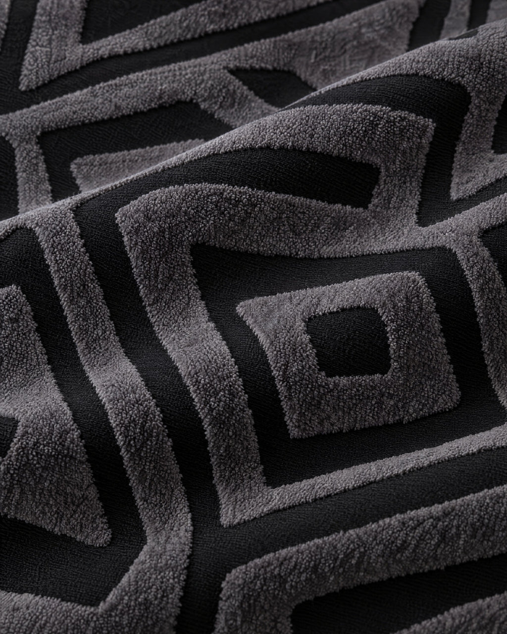 Charcoal Black: Close-up of the fabric of the Luxury Urban Maze Sofa Cover