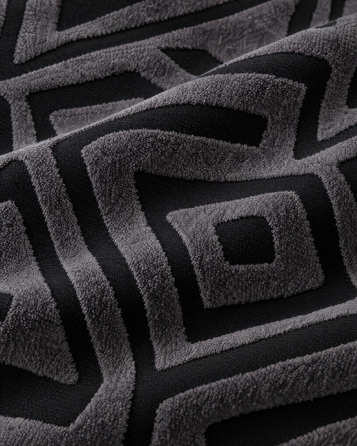 Charcoal Black: Close-up of the fabric of the Luxury Urban Maze Sofa Cover