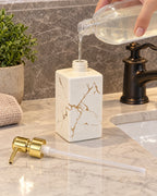 White: The Marble Soap Dispenser, Square Ceramic, Gold Pump being refilled, pump set aside