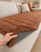 Chestnut Haze: Corner lifted to show the non-slip backing of the Metro Line Quilted Couch Cover Mat