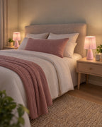 Pink: Two Milkshake Ceramic Cone Nightstand Lamp lamps flanking a bed at night