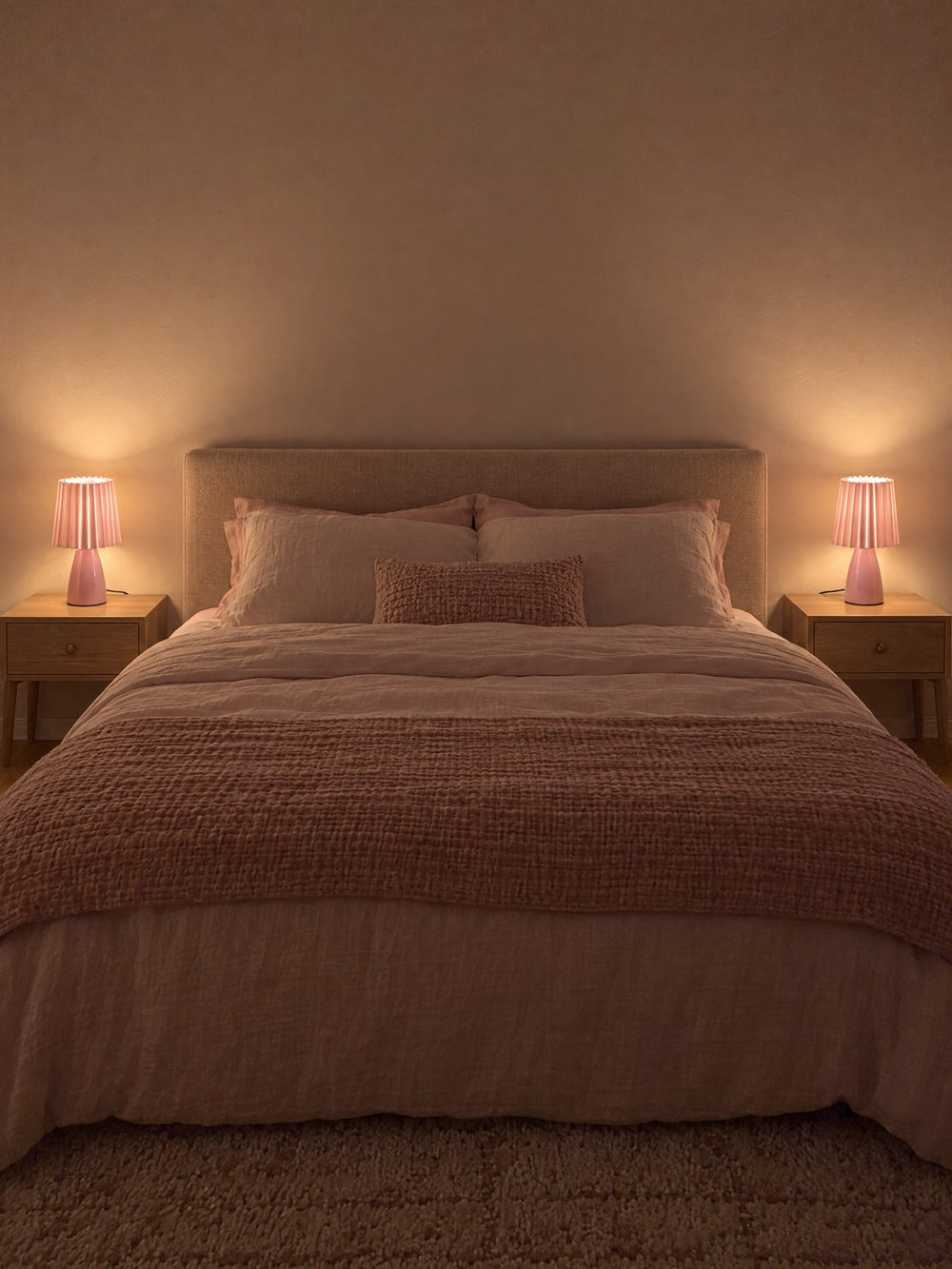 Two Milkshake Ceramic Cone Nightstand Lamp lamps on either side of a bed at night