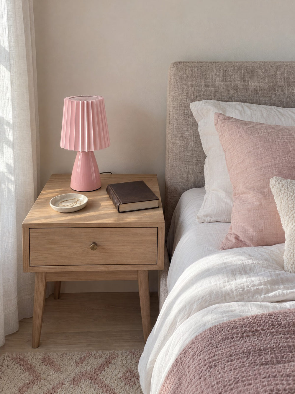 Milkshake Ceramic Cone Nightstand Lamp on a nightstand in daylight