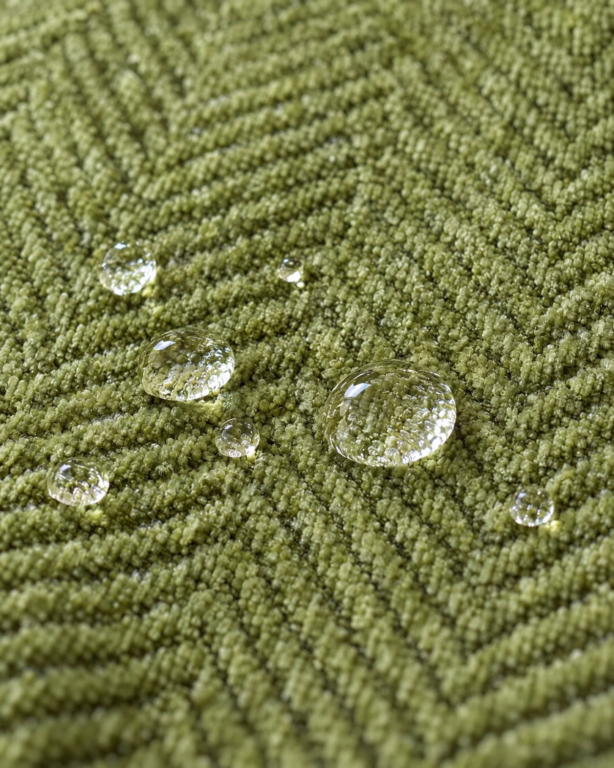 Green: Water droplets beading on the fabric of the Minimalist Sofa Cover