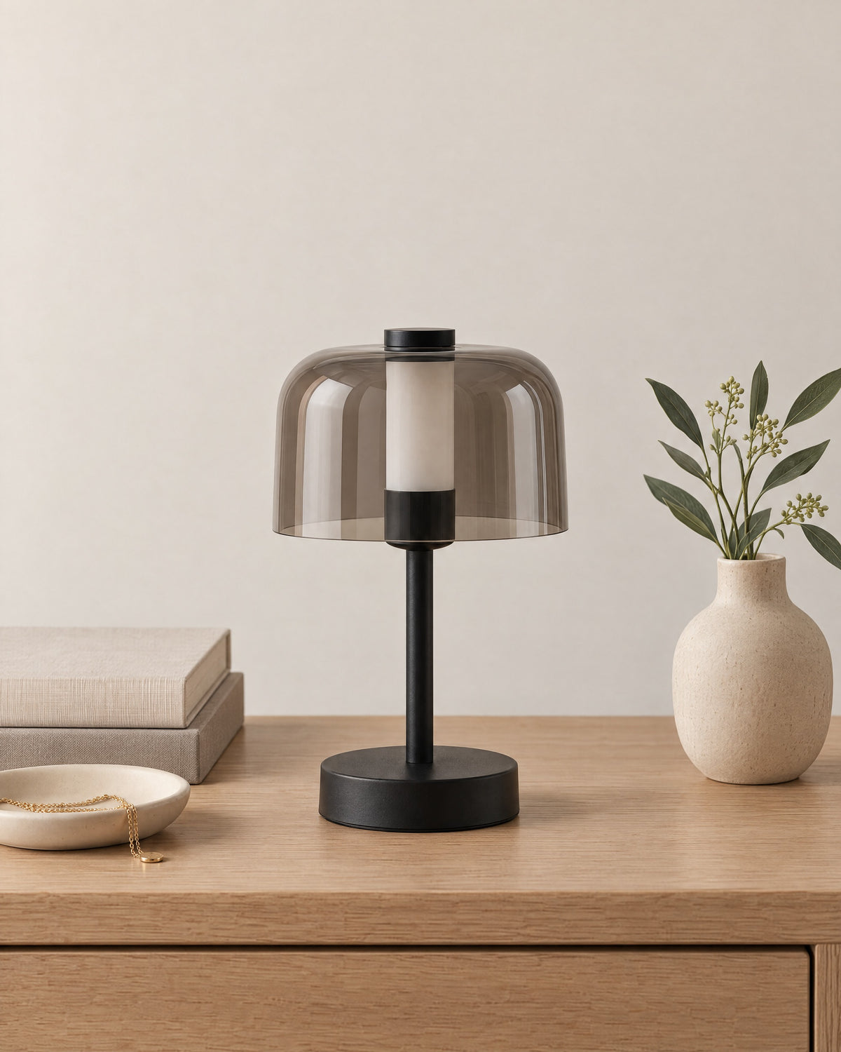 Black: Noir Cordless Dome Nightstand Lamp in black on a nightstand top against a light studio backdrop