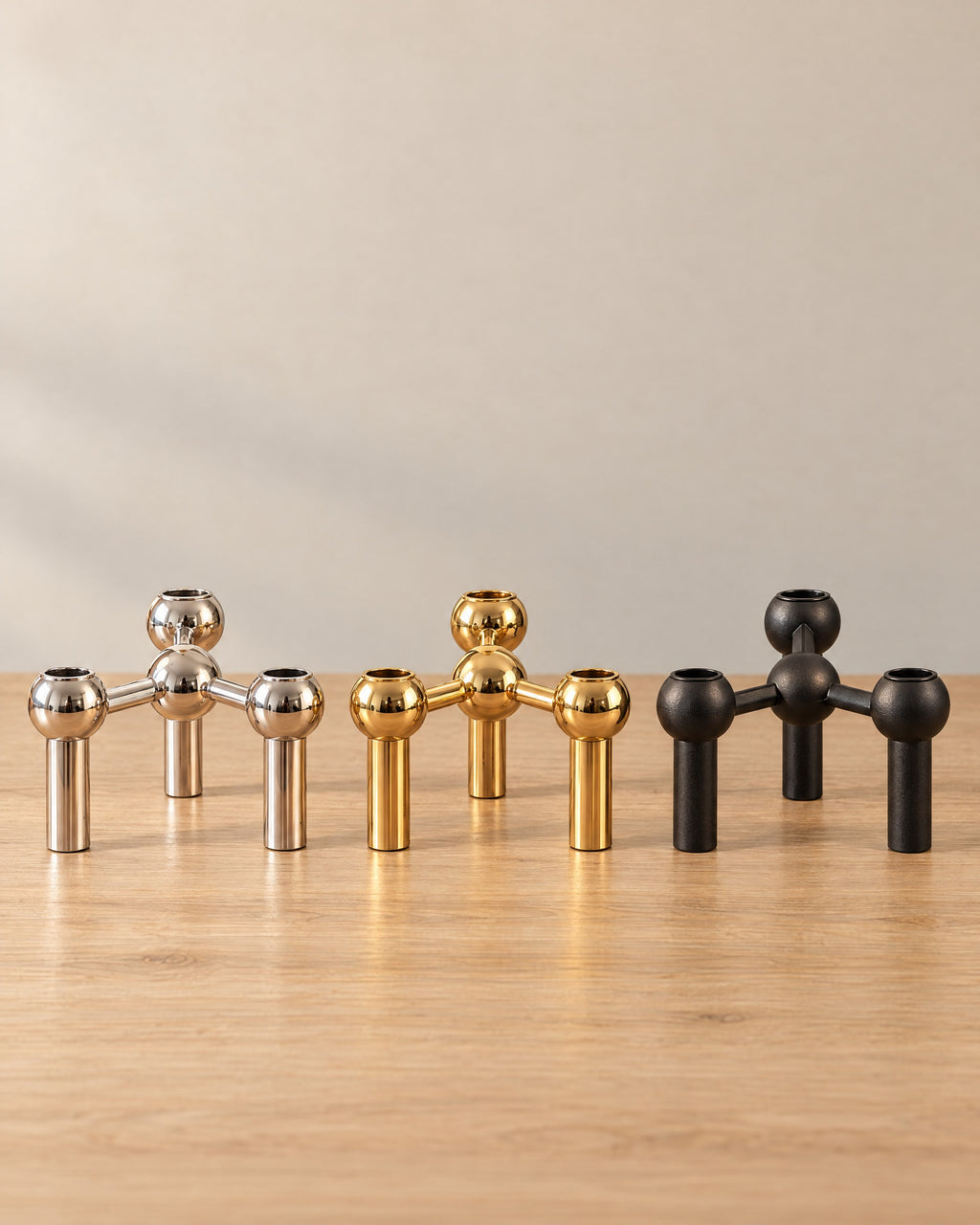 All colourways of the Orbit Stackable Metal Candlestick side by side: Silver, Gold, Black