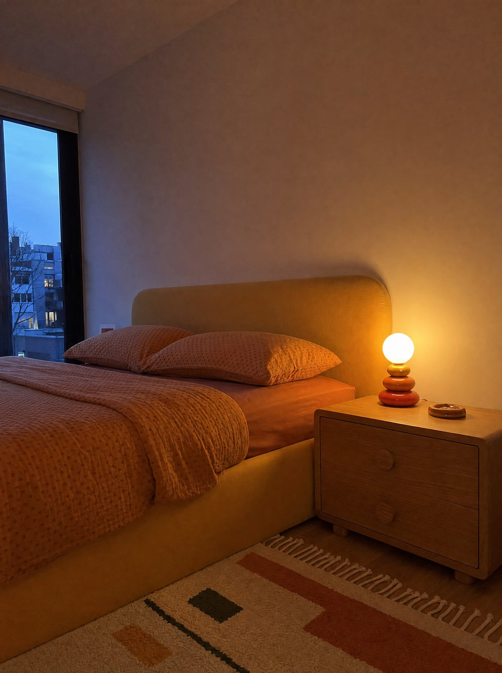Pebble Stack Ceramic Nightstand Lamp, at dusk