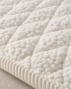 Ivory Bliss: Close-up of the fabric of the Pet-Proof Textured Quilted Sofa Protector Slipcover