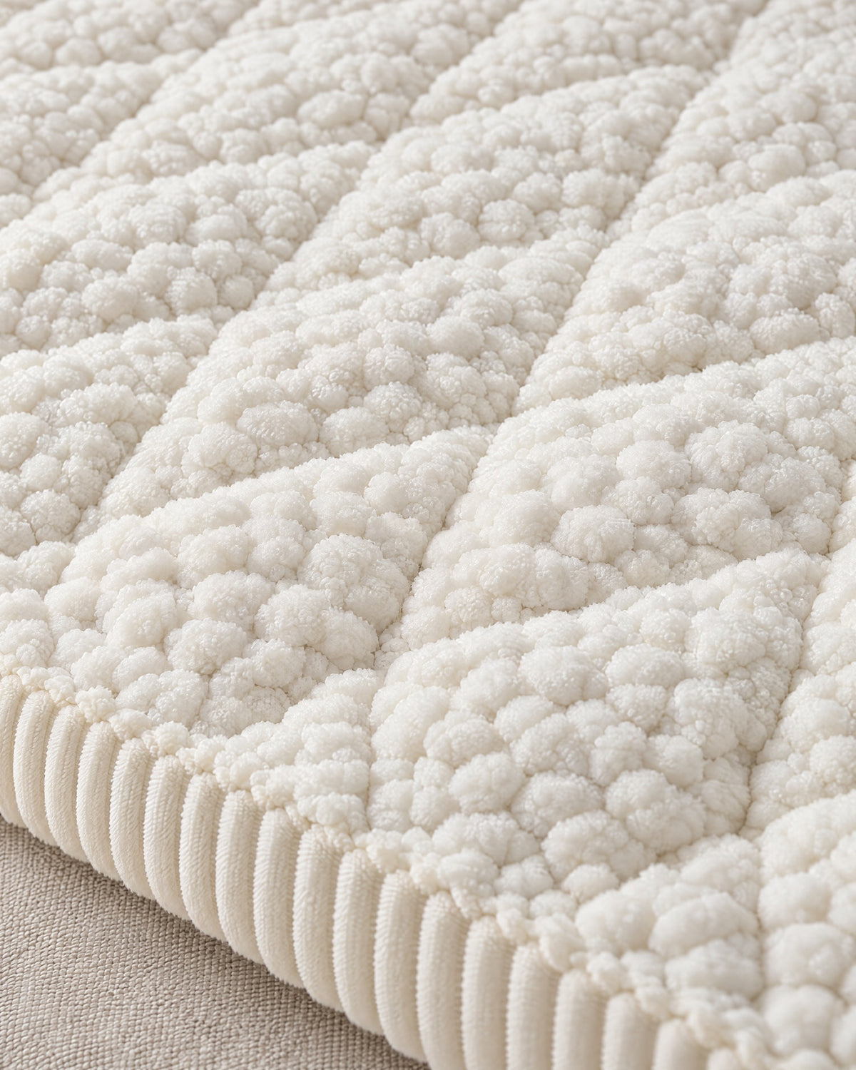 Ivory Bliss: Close-up of the fabric of the Pet-Proof Textured Quilted Sofa Protector Slipcover