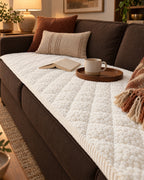 Ivory Bliss: Pet-Proof Textured Quilted Sofa Protector Slipcover on a cozy lived-in sofa