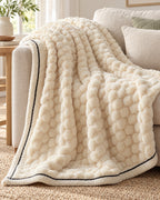 Popcorn Fleece Throw Blanket, Cream, Jacquard Texture draped over a sofa