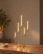 Quinta Five-Arm Iron Candelabra, lit, on a styled surface in the evening