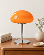 Orange: Retro Glass Mushroom Nightstand Lamp on a nightstand top against a light studio backdrop