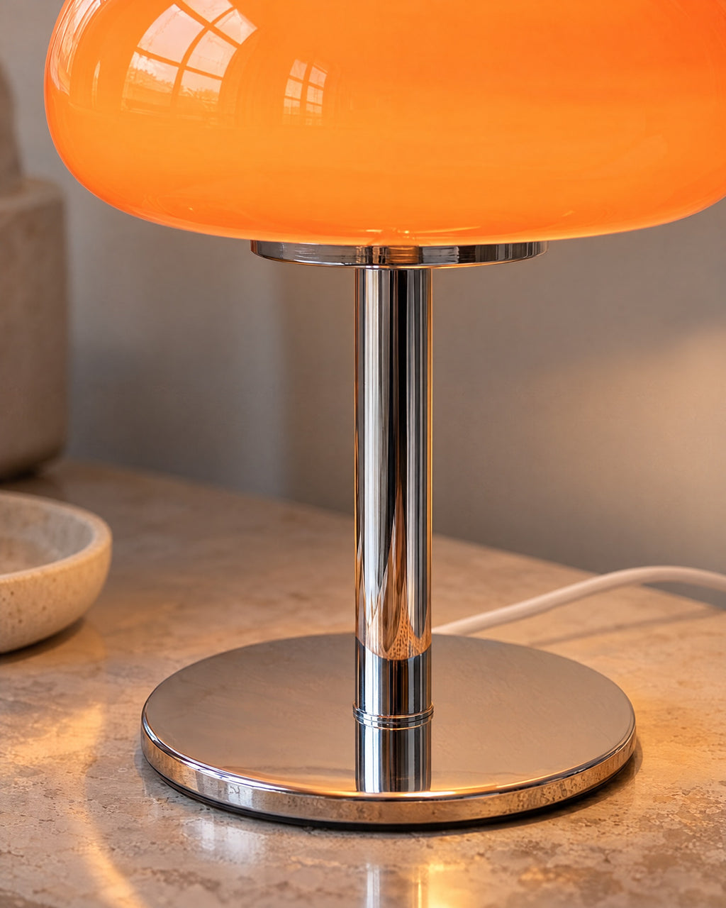 Orange: Close-up of the glass dome and polished chrome stem of the Retro Glass Mushroom Nightstand Lamp