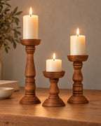 Bosco Farmhouse Wood Candle Holders, Set of 3, lit, on a styled surface in the evening