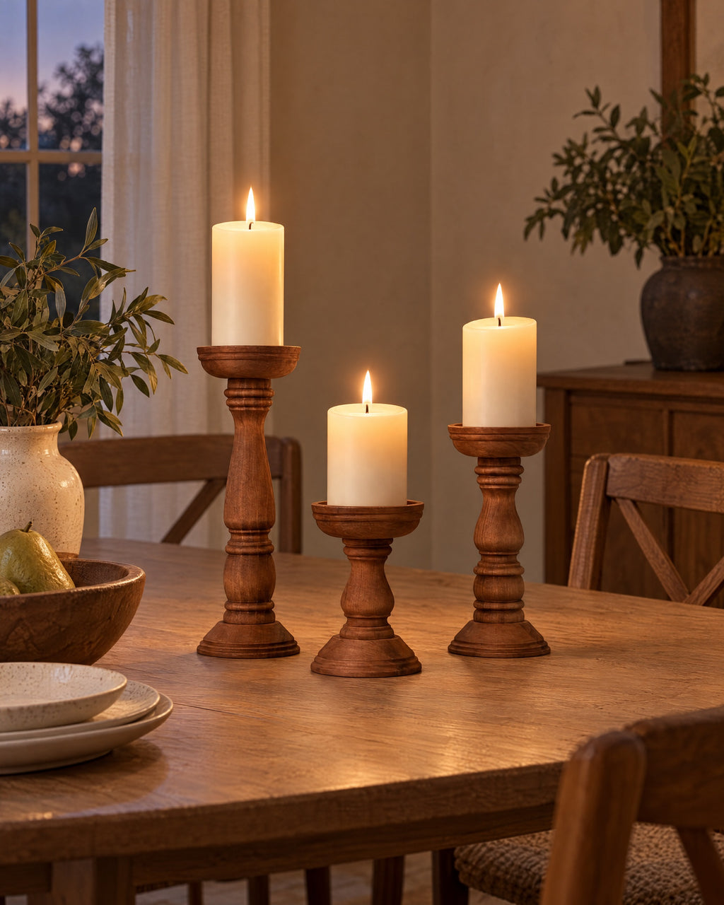 Bosco Farmhouse Wood Candle Holders, Set of 3 styled in a warm interior at dusk