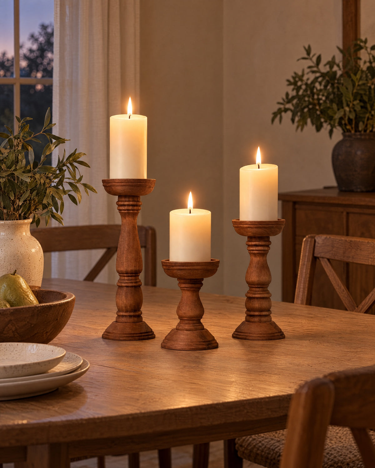Bosco Farmhouse Wood Candle Holders, Set of 3 styled in a warm interior at dusk