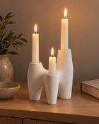 Duna Sculptural Ceramic Candle Holder, lit, in a lived-in evening scene