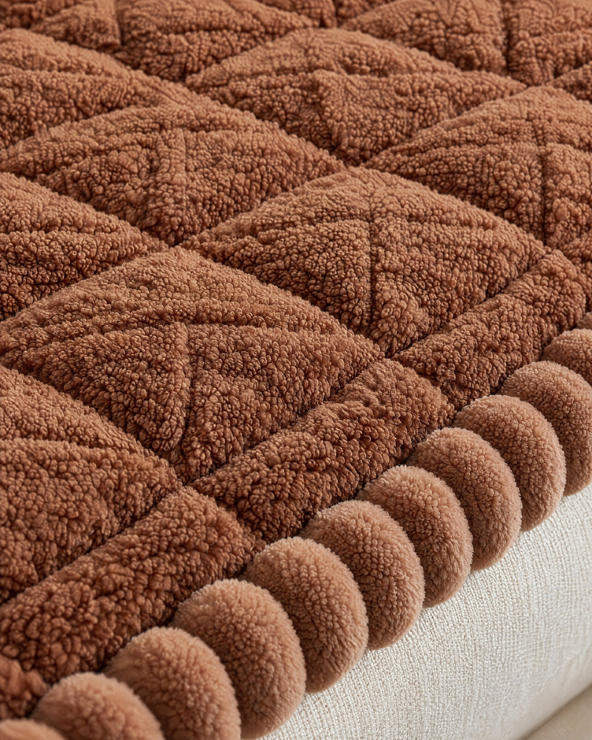 Mocha Brown: Close-up of the fabric of the Snuggle Sherpa Plush Sofa Protector Cover