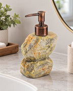 Stacked Stone Soap Dispenser, Ceramic, Bronze Pump, 10.5 oz on a bathroom vanity in soft daylight