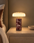 Red Marble: Stone Cordless Marble Nightstand Lamp switched on on a nightstand in the evening