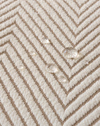 Ivory Sand: Water droplets beading on the fabric of the Stripe Herringbone Sofa Cover