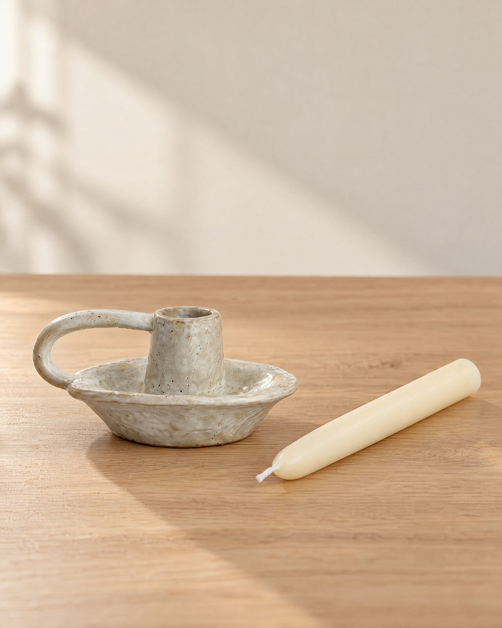 Wabi Speckled Ceramic Chamberstick with the candle type that fits, shown beside it