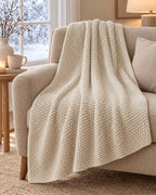 Waffle Knit Throw Blanket, Cream, All-Season draped over an armchair by a winter window