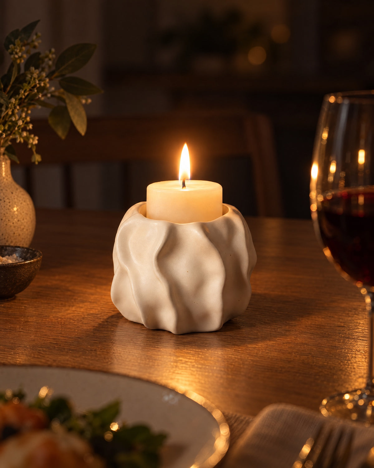 Low & Wide: Wave Abstract Ceramic Candle Holder with candles lit at night on a dinner table