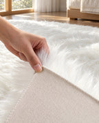 Corner lifted to show the suede non-slip backing of the White Faux Sheepskin Area Rug, Washable