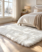 The wider 3.9 x 5.9 ft size of the White Faux Sheepskin Area Rug, Washable in a bedroom