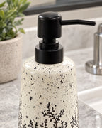 Close-up of the glaze and pump finish of the White Soap Dispenser, Speckled Ceramic, Black Pump, 11 oz