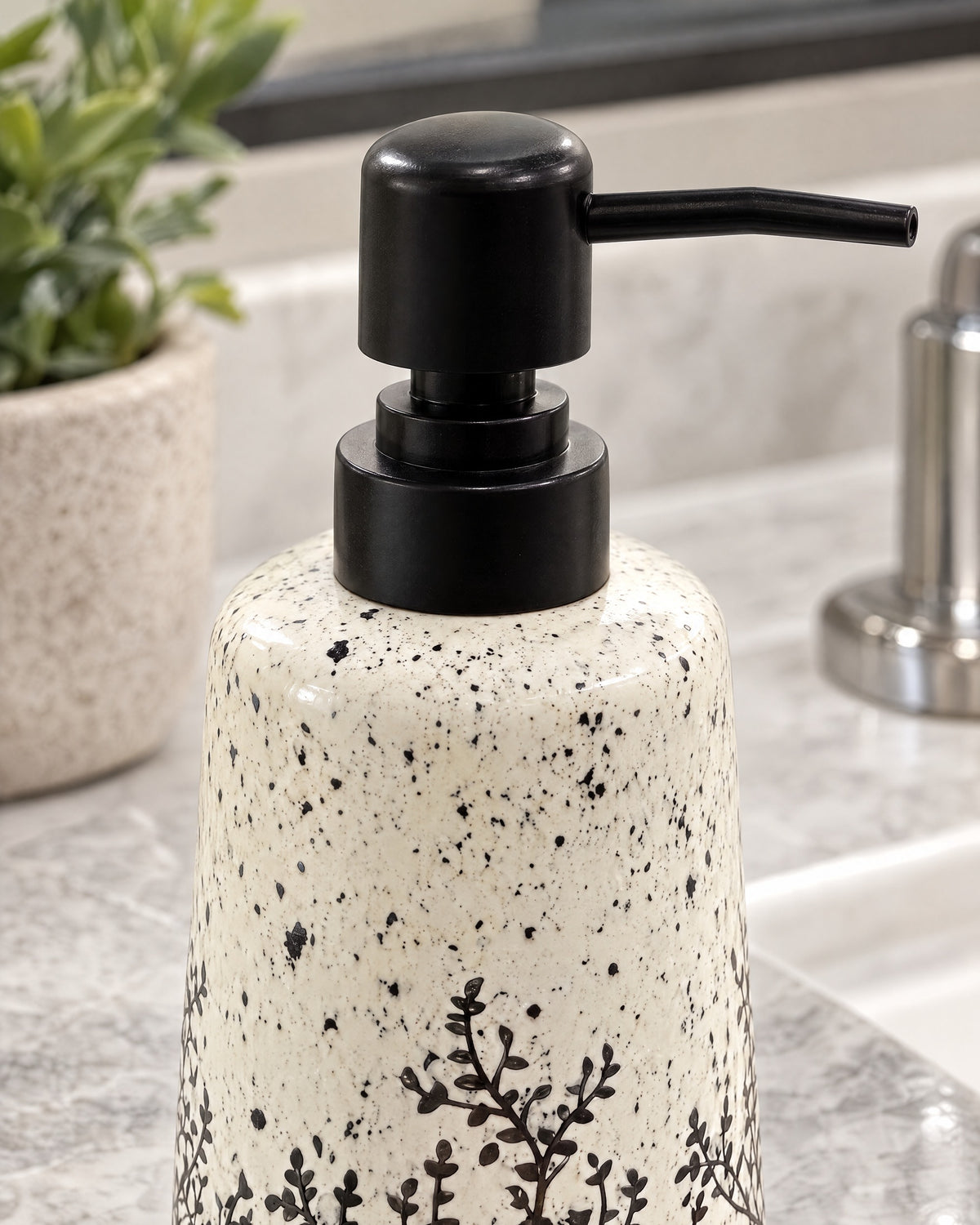 Close-up of the glaze and pump finish of the White Soap Dispenser, Speckled Ceramic, Black Pump, 11 oz