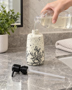 The White Soap Dispenser, Speckled Ceramic, Black Pump, 11 oz being refilled, pump set aside